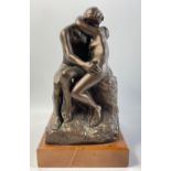 An AUSTIN copy of THE KISS on a wooden plinth 18x16x29cm