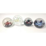 Four large glass paperweights to include the CAITHNESS Moonflower