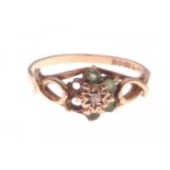A 375 hallmarked floral set yellow gold ring with green stones (2 missing), size N, gross weight