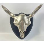 An amusing mounted steel / aluminium steer's head skull on a wall plaque