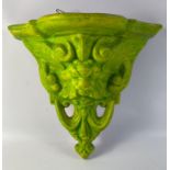 AN UNUSUAL TERRACOTTA wall mounted planter finished in a lime/greenish finish with a MENACING