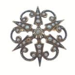 A vintage brooch indistinct 15ct stamp set with seed pearls in a star shape (1 seed missing),