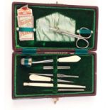 An Edwardian ladies personal tool set complete with a hallmarked silver thimble