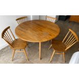 STAR ERCOL FURNITURE PIECE!A light oak round two-leaf folding dining table with 4 spindle ERCOL