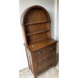 An ERCOL inspired small dresser in dark oak with a semi-circular hooded-plate rack with 2 drawers