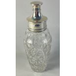 A nice quality cut-glass cocktail shaker with silver hallmarked collar, strainer and stopper,