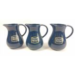 Three blue coloured Whyte and Mackay water jugs