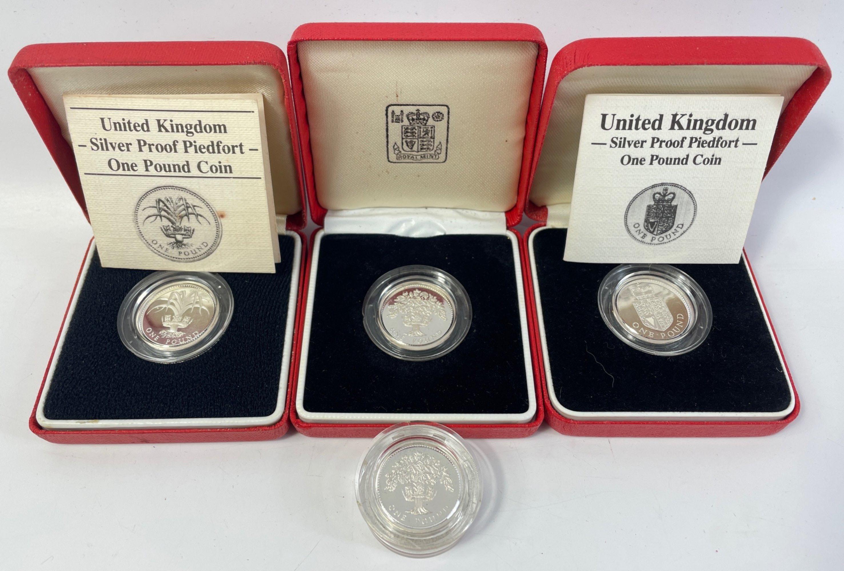 Four ROYAL MINT United Kingdom silver proof Piedfort one pound coins, three in boxes, 2 with