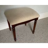A dressing-table stool with cream upholstery