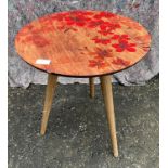 A retro three spindle legged table with a hand painted floral top - dimensions diameter 45cm x