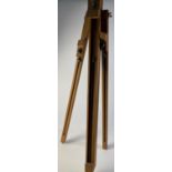 A foldaway standing wooden easel, closed length 83cm