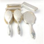 A silver monogrammed dressing table set comprising a hand mirror, 2 hair brushes and 2 clothes