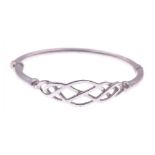 A white metal bangle with broken catch