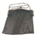 A ladies gold coloured metal mesh evening purse with a chain handle 10cm long x 19cm wide approx