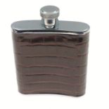 A small pocket flask with leather covering 6.5cm x 7.5cm
