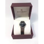 A boxed gent's titanium ACCURIST watch with black face and silver numerals, (Japan MVT GL10) model