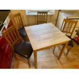 A nice wee dining set with a light oak style dining table and four dining chairs with brown