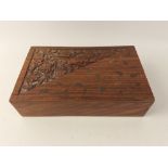 An attractive Indonesian hardwood box with decorative carving and brass inlay