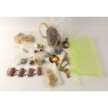 A bag of costume jewellery to include some large clip-on earrings, chunky bracelets and rings