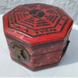 A lucky Hong Kong red octagonal wooden box covered with leather and also metal hasp and handles