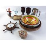 A mixed lot of decorative items to include two African wooden goblets, a ship's wheel thermometer,