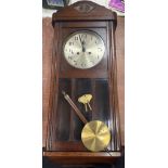 A very attractive early Twentieth Century wall clock complete with pendulum and both keys in