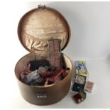 A vintage hat travel box containing gentlemen's accessories such as braces, ties, studs, garters,