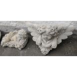Two cherub garden ornaments to include one lying on grapes (30cmL) and a wall hanging cherub