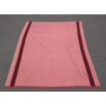 A woollen rug in a warming shade of red, measures 170x 200cm approx