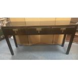 A STYLISH ORIENTAL inspired long console table finished in a black lacquer paint with three