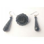 A jet flower shaped brooch 2.5cm dia and a pair of jet drop earrings on 925 stamped posts each 4cm