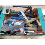 A box of assorted tools and household items to include an axe, a plane, shears, files, wire