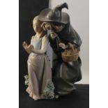 An expressive LLADRO figurine group of a young girl being offered an apple by an elderly woman in