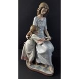 A LLADRO figurine of a lady and child reading from 1987 stands 27cm high, no cracks, chips or