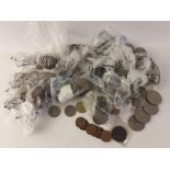 A quantity of obsolete UK coinage sorted into bags as well as some Crowns and three collectible