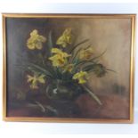 An oil on canvas still life of a glass vase depicting narcissi ,artist initials B.C.T