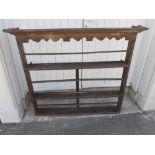 An antique Victorian wooden wall plate rack