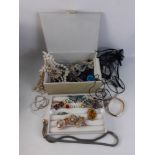 An attractive cream leather jewellery case containing a super mixture of costume jewellery