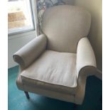 A comfortable cream upholstered armchair