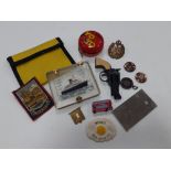 A small mixed lot of trinkets to include small Lone Star cap gun, Beatles badges, RAF cap badge,