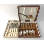 A boxed set of 5 EPNS teaspoons with cheese knife and a set of 5 butter knives,