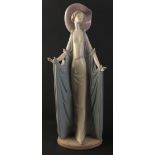 A beautiful tall LLADRO figure of a svelte female in hat and flowing gown