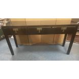 A STYLISH ORIENTAL inspired long console table finished in a black lacquer paint with three