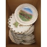 A large collection of decorative plates mostly with cut-out design on edges and many commemorating