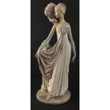 A beautiful LLADRO 1920s female figurine in flowing gown standing next to classical column and