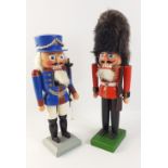 Two wooden painted Christmas soldiers each approx 30cm tall, one a guardsman, the other more