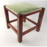 A small wooden footstool with a padded velour seat, measures 30x30x30cm approx