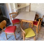 A RETRO 1960's formica topped drop-leaf dining table with 2 drawers with also two original chairs