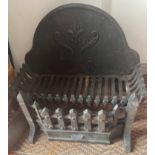 A medium sized dog-grate with Fleur de Lys pattern - dimensions height 40cm height x 52cm width