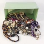 A box of costume jewellery of the chunky beaded sort, mainly necklaces with some semi-precious